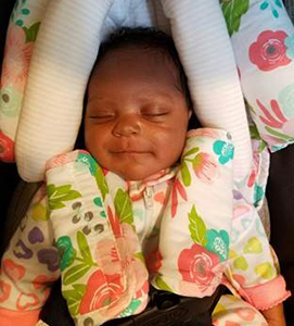 Sleeping African American baby girl in her carseat