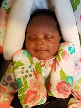 Sleeping African American baby girl in her car seat