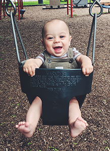 happy baby in a swing