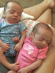 Twin sleeping newborn baby girls