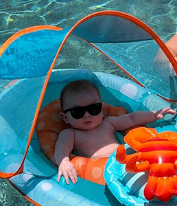 Baby with sunglasses in floating raft
