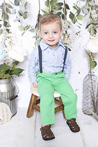 Portrait of a little boy in green pants and suspenders