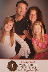 Adoptive family poses for a Christmas card