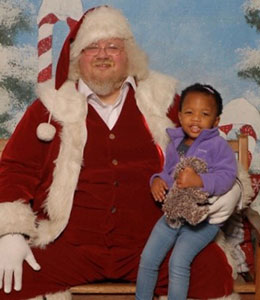 African American little girl in Santa's lap
