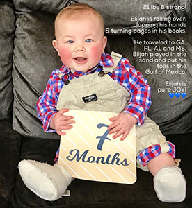 Seven-month-old baby Elijah in overalls