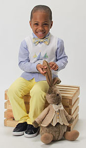 Portrait of a happy black boy next to a stuffed animal bunny