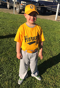 Boy in yellow baseball uniform