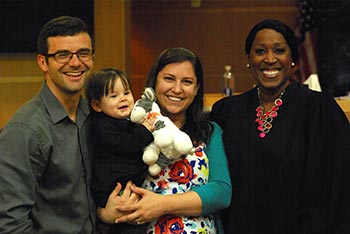 Adoptive parents Matt and Andrea with their son and the judge at adoption finalization