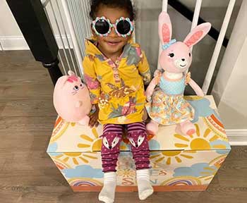 cute black baby girl dressed up for Easter festivities with her chick and bunny friends