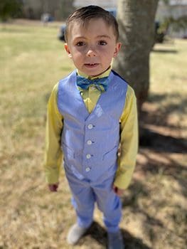 already five, adopted son poses in his Easter suit outdoors