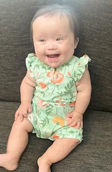 happy baby laughs at picture taker