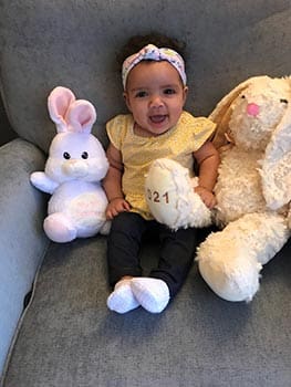 Posing with her bear and bunny