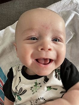 happy baby smiling at photographer