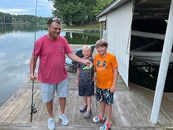 Dad and boys with the fish they caught