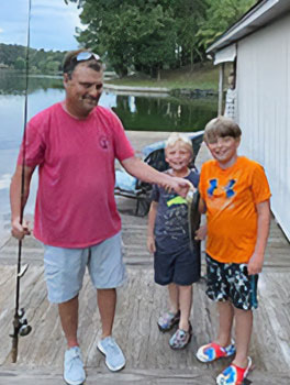 Dad and boys with the fish they caught