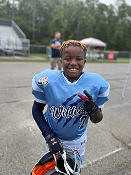 young boy in football uniform