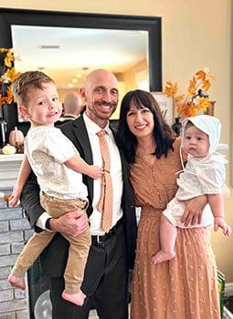 family celebrates baby's baptism
