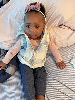 very cute baby poses for a photo