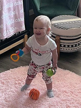 adored by all, little girl shows off her toys in her room