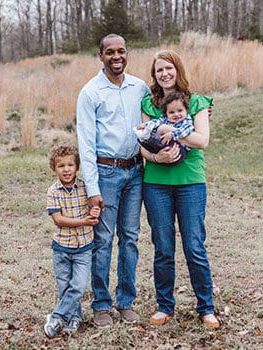 a happy adoptive family pose for photo