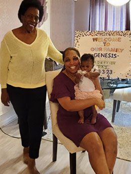 Three generations pose for a photo