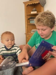 Hunter reads to his baby brother Cole