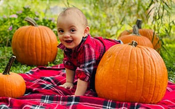 cute as the pumpkins this baby wanders through