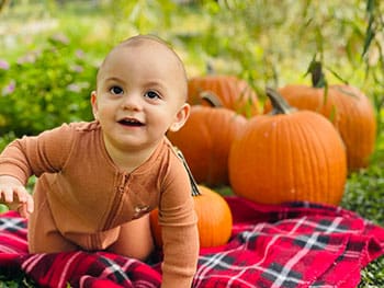 cute as the pumpkins this baby wanders through