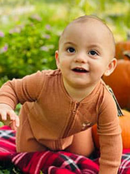 cute as the pumpkins this baby wanders through