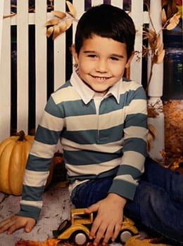 Liam turning 4 and  sitting in a pumpkin patch
