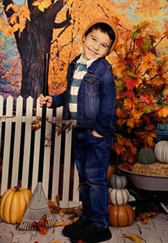 Liam turning 4 and standing in a pumpkin patch