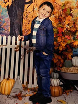 Liam turning 4 and standing in a pumpkin patch