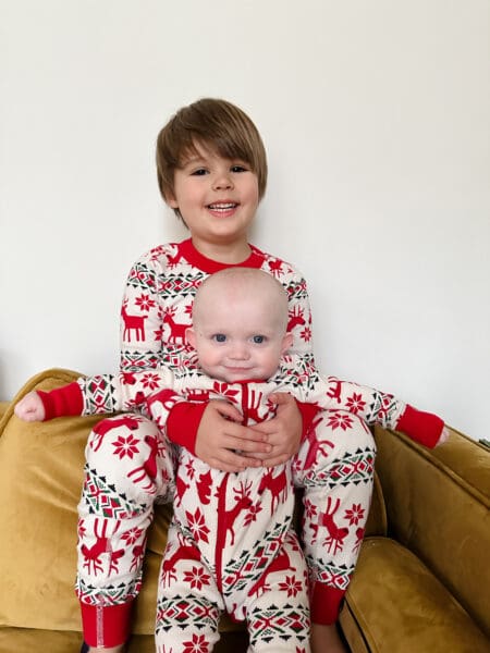 baby and big brother pose in matching PJs