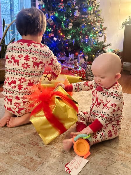 baby tries to unwrap her first Christmas present