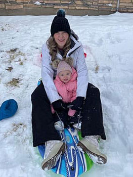 Mom and Carson sledding in the snow