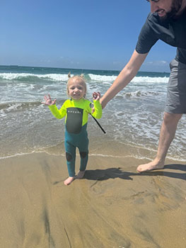 Young girl enjoying the ocean with her Dad